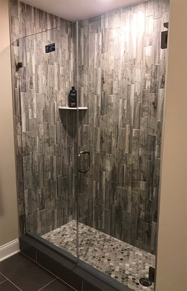 gray stone shower with clear shower doors