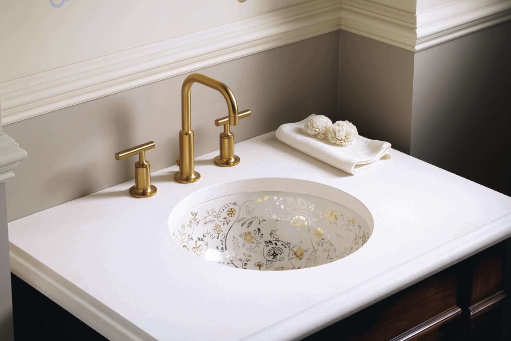 gold faucet with white sink