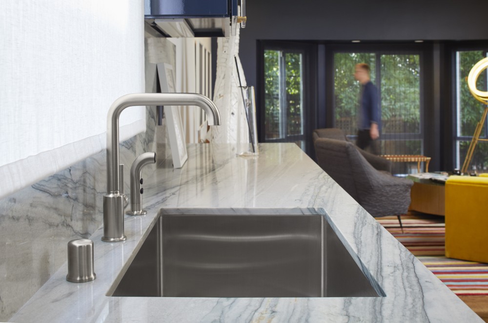 white and gray marble kitchen countertop with silver sink faucet