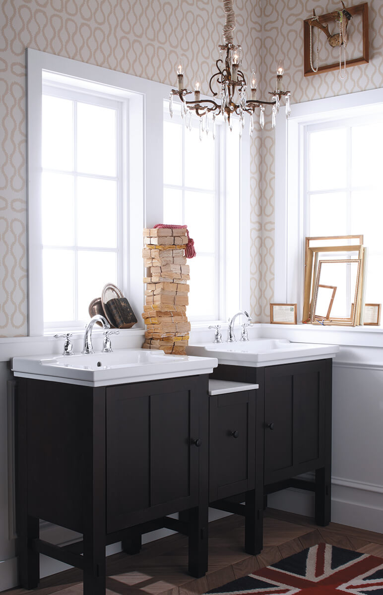 dark wood bathroom vanity with white sink and windows