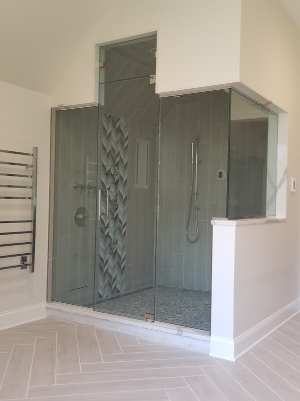 large shower with tall ceilings and lots of glass