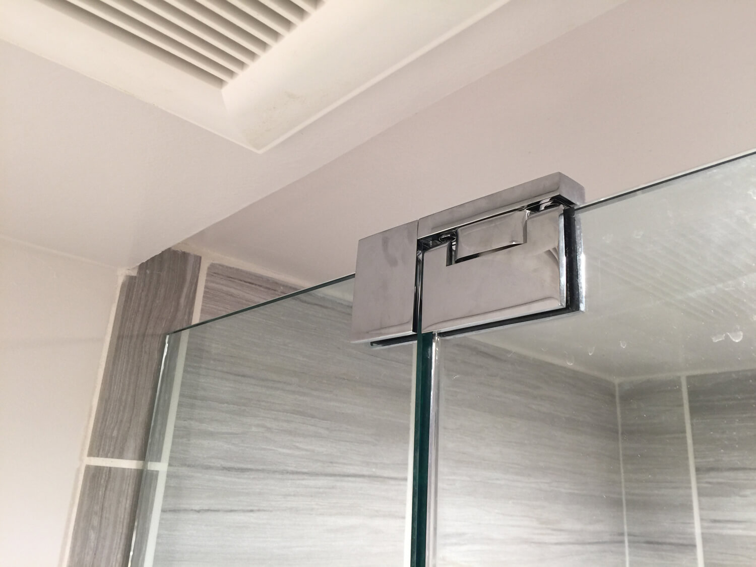 silver shower hinge for a frameless glass shower door