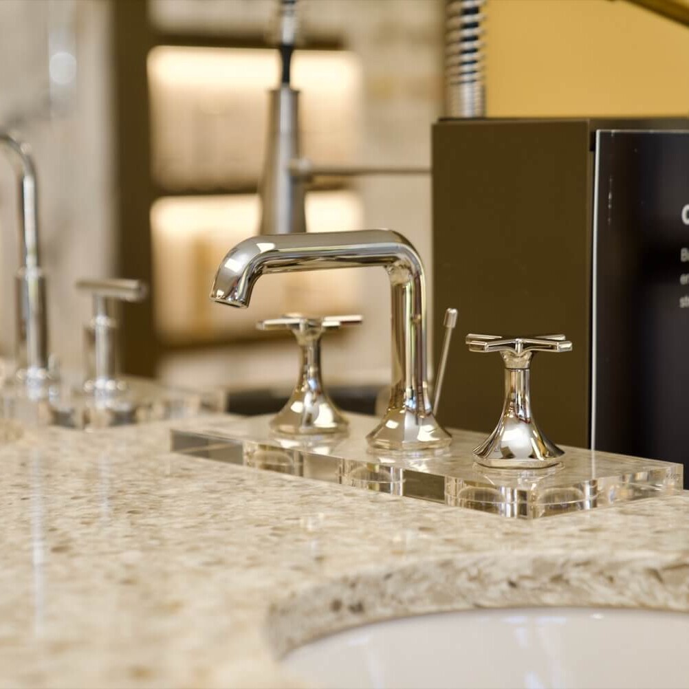 Model sink faucets on display